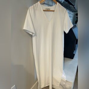 Short sleeved white, dress- polyester with bottom side slits.